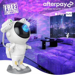 Cartoon astronaut figure standing in a purple-lit bedroom with a galaxy projector glow, promoting an astronaut galaxy projector