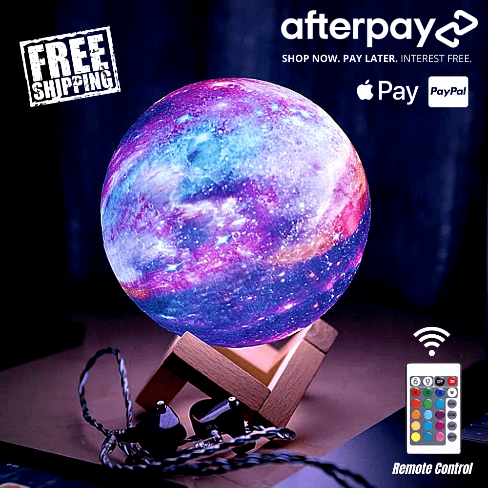Color-changing galaxy moon lamp with vibrant purple and blue hues, sitting on a wooden stand and remote-controlled for ambient night lighting.