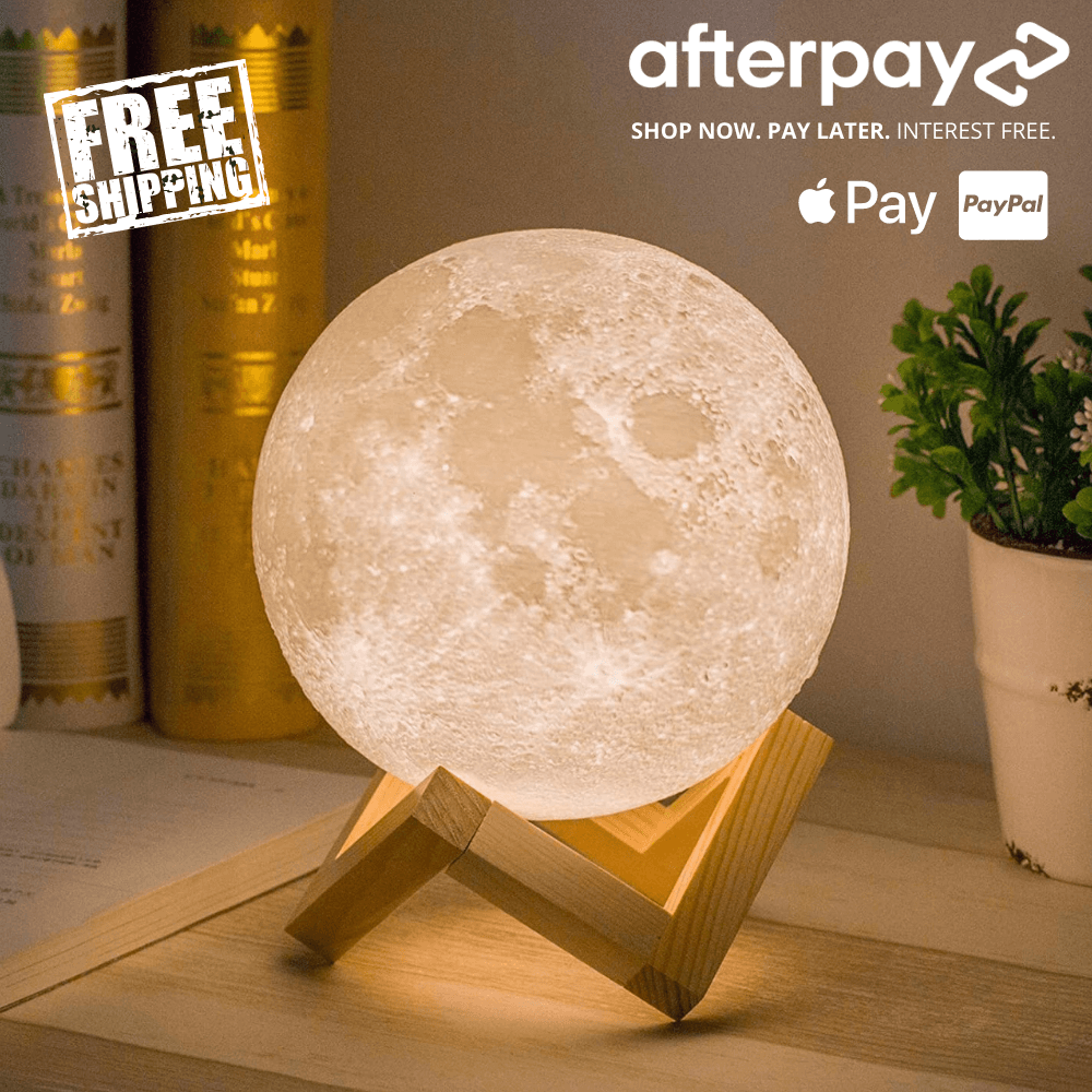 Warm white moon lamp with realistic lunar surface texture, displayed on a wooden stand as cozy ambient decor for a bedside or desk.